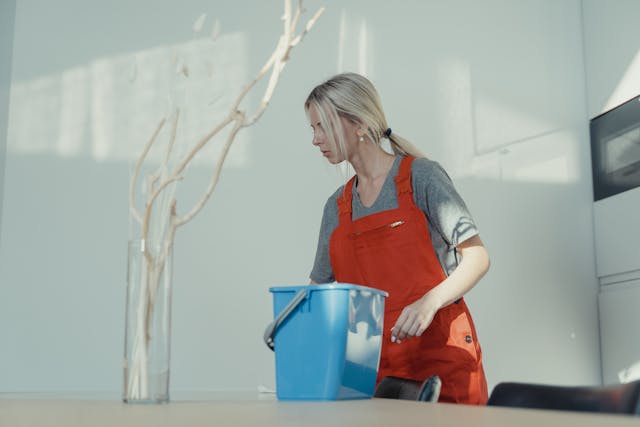 Cleaner preparing equipment to clean an office meeting space
